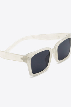 Marble effect rectangular sunglasses with dark lenses and transparent frames.