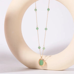 Neon green orb & chain necklace with oval pendant and gold-tone metal.