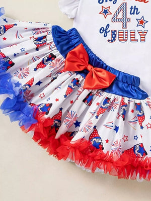 Baby girl's festive 4th of July outfit with gnome print skirt and red bow.