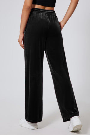 Black velvet palazzo lounge trousers with side stripe detail and elastic waistband.