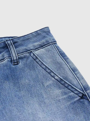 Relaxed high-waisted denim maternity jeans in light blue with pockets and cuffed hem detail.