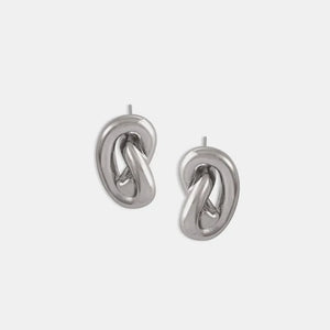 Sculptural knot stud earrings in silver with a polished finish.