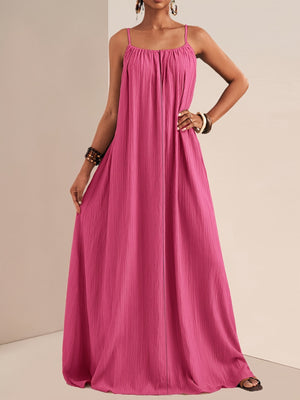 Fuchsia pink maxi swim dress with spaghetti straps and textured fabric.