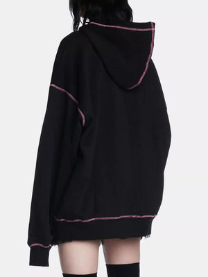 Black zip-up hoodie with pink contrast stitching and raw hem detail.