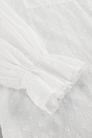 White textured ruffle trim shirt with gathered sleeves and a dotted pattern.