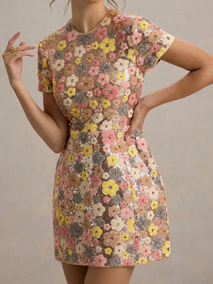 Floral sequin mini dress with short sleeves and a colorful floral pattern.