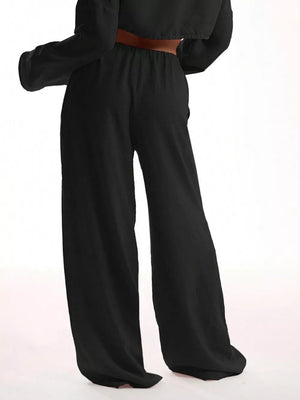 Black maternity pants with a relaxed wide-leg cut and elastic waistband.