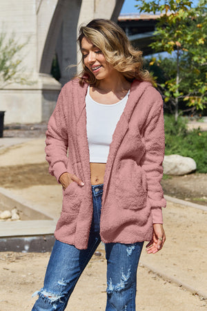 Plush hooded cardigan jacket in blush pink with open front and pockets.