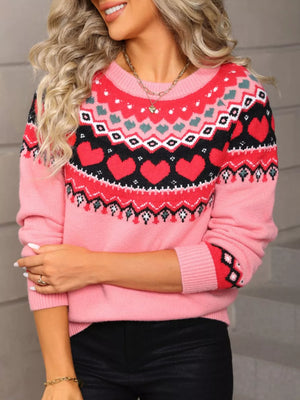 Pink acrylic sweater with crew neck and festive heart motif pattern.