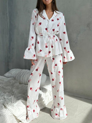 White cotton button-down pajama set with red and pink hearts and ruffled cuffs.