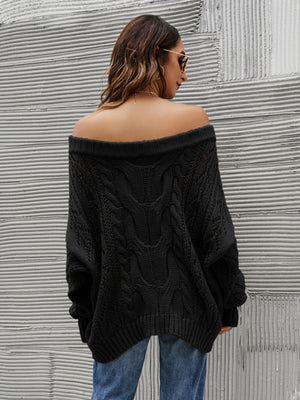 Black cable knit off-shoulder slouch sweater with detailed knit pattern.