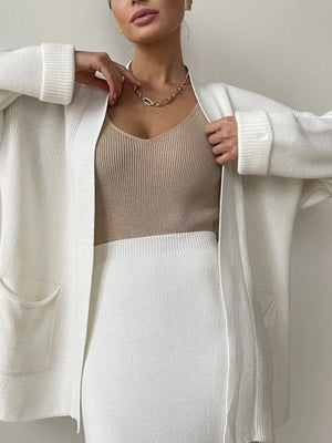 Ribbed knit co-ord set in cream featuring a long sleeve cardigan with pockets and a V-neck cami.