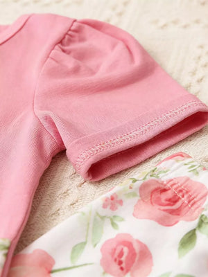 Pink ruffled sleeve baby top with floral print pants.