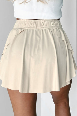 Beige ruffled skort with elastic waistband and tie detail