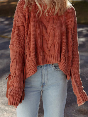 Chunky oversized cable-knit sweater in rust orange, cropped length, with a cotton blend.
