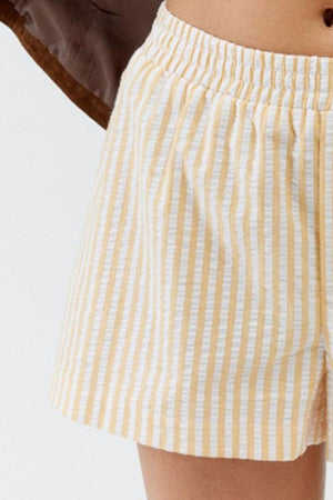 Seersucker boxer shorts in pastel yellow and white stripe with elastic waistband.