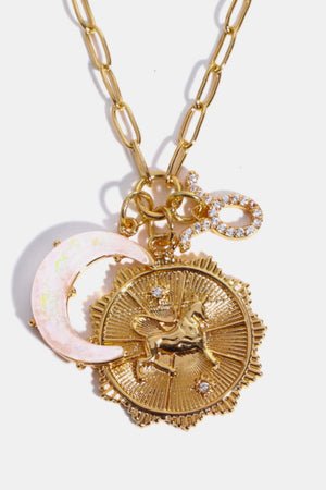 Gold celestial pendant necklace with unicorn, moon, and zodiac symbol charms.