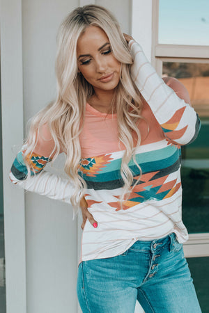Crewneck shirt with Aztec print sleeves and pink body.