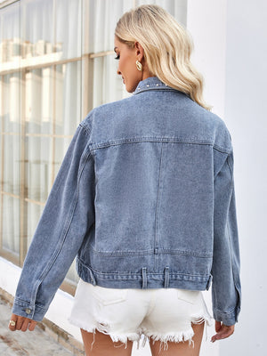 Medium wash denim trucker jacket with pearl embellishments on the collar.