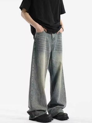 Men's relaxed fit vintage wash jeans with a baggy cut and gradient color detail.
