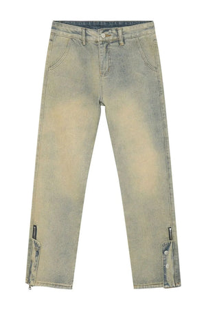 Light wash denim jeans with distressed details and split hems with zippers and snap buttons.