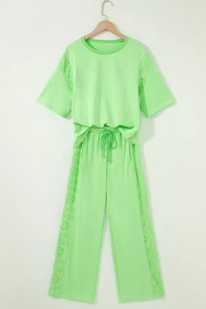 Lime green cotton two-piece set with embroidered eyelet details on the sleeves and pants, featuring a drawstring waist.