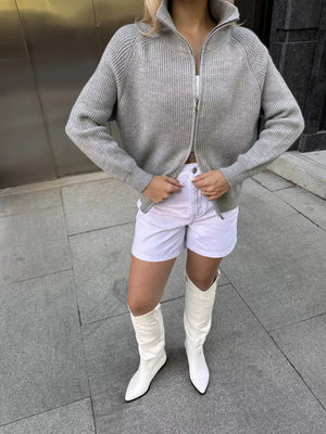 Gray ribbed knit zipper cardigan with a stand-up collar and full zip closure.