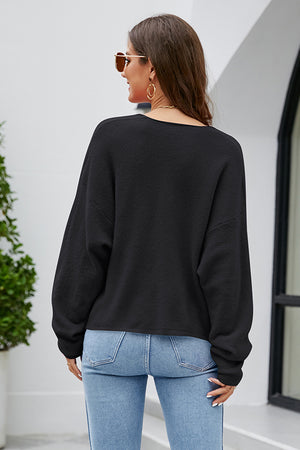 Black fluffy knit sweater with a plunging neckline and long sleeves.