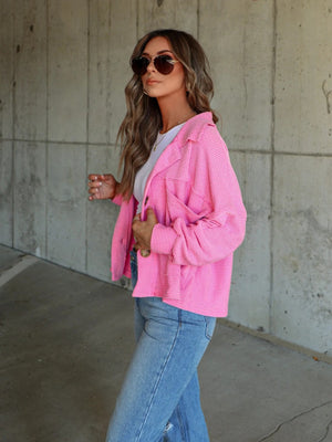 Textured boxy utility shirt jacket in fuchsia pink with button details and a relaxed fit.