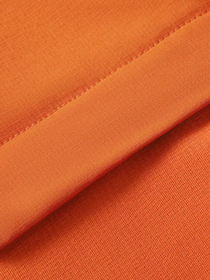 Orange long sleeve tee showing textured fabric and stitched seam detail