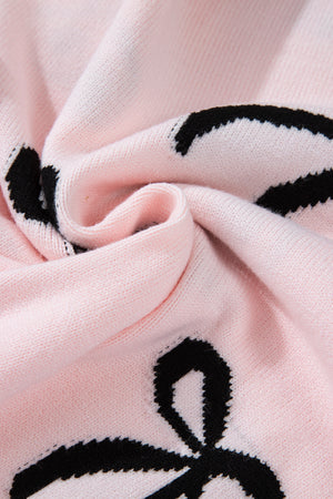 Blush pink knit sweater with black bow motifs, crewneck detail