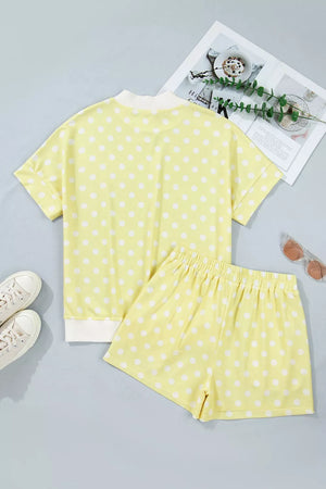 Pastel yellow polka dot top and shorts set with white trim, polyester.