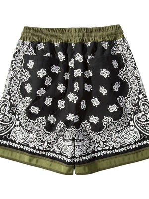 Black bandana print sport shorts with green waistband and metallic trim detail.