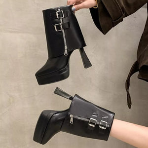 Black ankle boots with pointed toe, platform, block heel, zipper and buckle straps.
