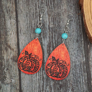 Autumnal pumpkin wood dangle earrings with turquoise beads and silver hooks.