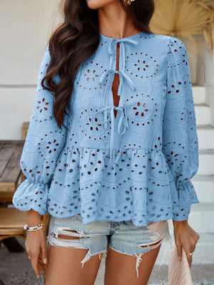 Light blue eyelet embroidered peplum blouse with tie neck and ruffled cuffs