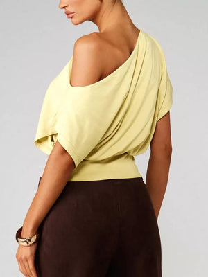 Yellow asymmetrical crop t-shirt with draped fit and short sleeves.
