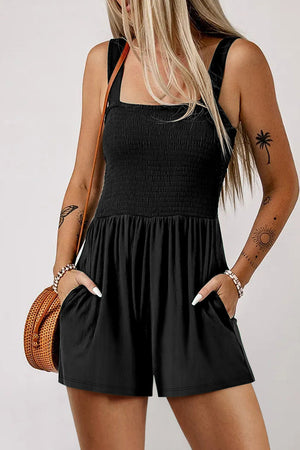 Black smocked bodice romper with square neck, adjustable straps, and pockets.