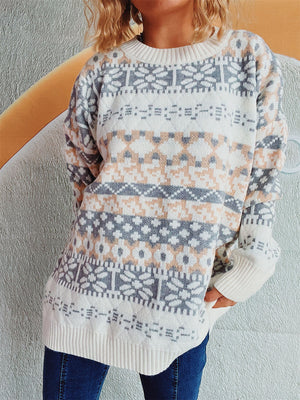 Fair Isle knit oversized sweater with crewneck and ribbed cuffs in white, grey, and peach pattern.