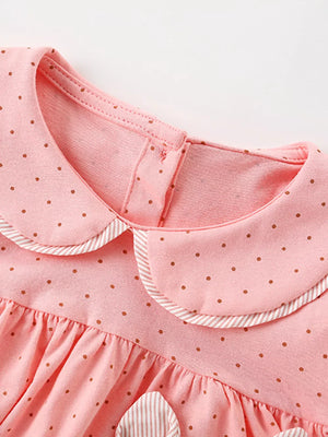 Pink polka dot cotton baby dress with Peter Pan collar and striped trim.