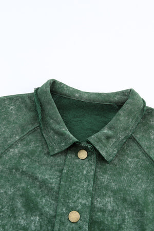 Green washed cotton utility jacket with distressed details and brass buttons.