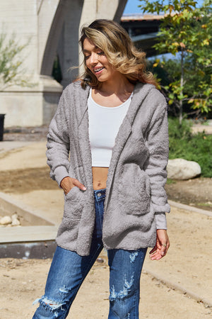 Plush hooded cardigan jacket in light gray with pockets and long sleeves.