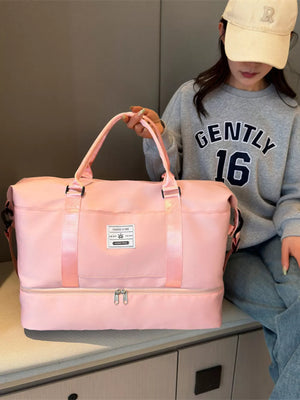 Light pink duffel bag with two zippered compartments and a patch detail.