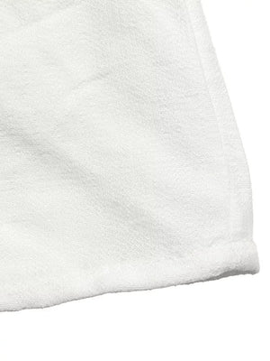 White terry cloth fabric detail with a hemmed edge