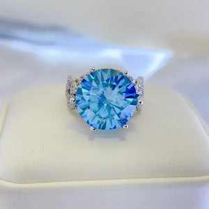 Celestial blue moissanite knot ring with pavé accents and a large round-cut blue stone.