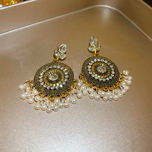 Beaded medallion and pearl drop earrings with crystal accents.