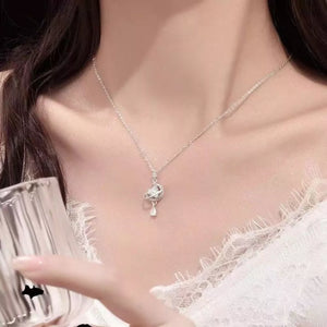 Celestial heart pendant necklace with a sparkling planet charm and teardrop accent.