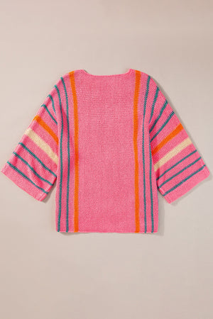 Colorblock sleeve knit pullover in pink with vertical orange and teal stripes and horizontal stripes on sleeves.