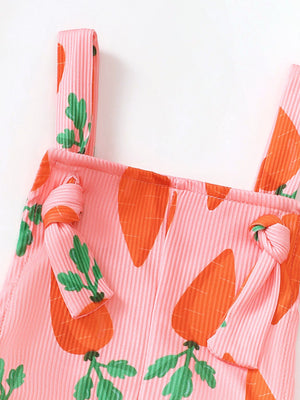 Pink ribbed overalls with carrot print and knot shoulder straps.