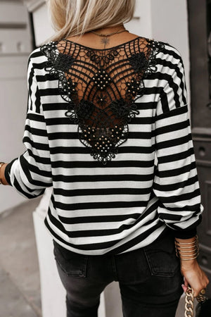 Black and white striped blouse with intricate black lace and pearl detail on the back.